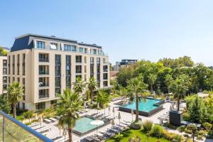 an apartment building with two pools and palm trees at Artistic space in Azur Premium in Varna City