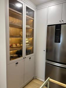 a kitchen with white cabinets and a refrigerator at Apartamento espaçoso Praia Brava in Itajaí +12 photos