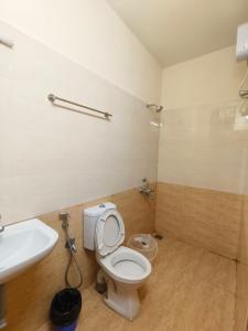 a bathroom with a toilet and a sink at Skyry Residency in Chennai