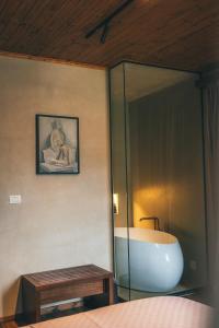 a bedroom with a tub and a table and a mirror at N'SOKAK Boutique Hotel in Gjirokastër
