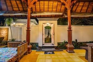 a room with a bed and a painting on the wall at Imagine Bali in Ubud +170 photos