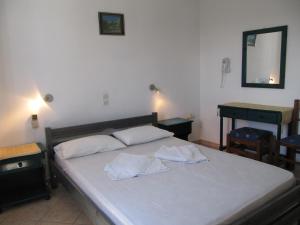 a bedroom with a bed with two towels on it at Petros Studios Kythera in Kythira