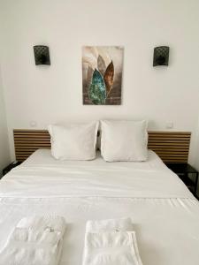 a bedroom with a white bed with two pillows at Maison le Bac Apartments in Paris