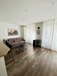 a living room with a couch and a table at Maison le Bac Apartments in Paris