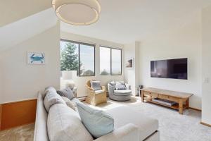 a living room with a couch and a tv at Timber & Tide in Sea Ranch