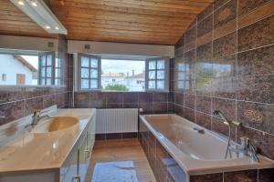 a bathroom with a large tub and a sink at Fripouille - A 100 m de la plage in Royan +11 photos