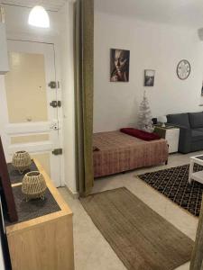 a bedroom with a bed and a living room with a couch at 3 minutes walking to monaco & the beach in Beausoleil
