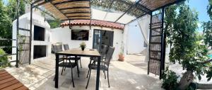 a patio with a table and chairs and a building at Summer app Pool Spa jacuzzi 2 in Makarska