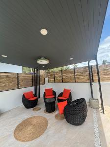 a porch with four chairs with red pillows on it at Villa Selva, Lamai in Amphoe Koh Samui +2 photos