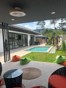a patio with a swimming pool and a house at Villa Selva, Lamai in Amphoe Koh Samui