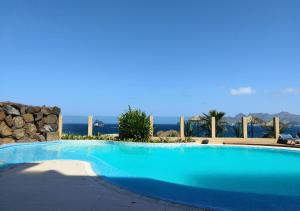 una piscina azul con vistas al océano en Lazareto Breeze T1, en Lazareto