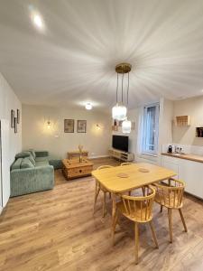 a living room with a table and a couch at Hypercentral Champagne Nest in Épernay