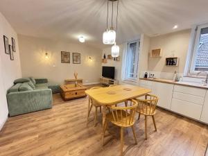 a kitchen and living room with a table and chairs at Hypercentral Champagne Nest in Épernay