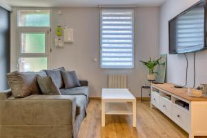 a living room with a couch and a table at L'instant 47 - Maison de ville - Parking gratuit in Sotteville-lès-Rouen