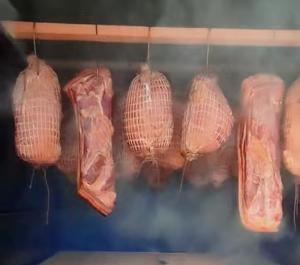 a bunch of meat hanging from a rack at Żurawisko - Domki wśród natury in Jesiona