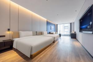 Postel nebo postele na pokoji v ubytování Atour Hotel Shantou Chenghai Guosheng Center