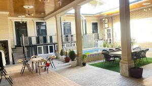a patio with a table and chairs and a pool at Saidi Silk Road Family Guest Room in Samarkand