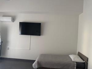 a bedroom with a bed and a flat screen tv on the wall at buonconsiglio 199 in Trento