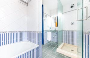 a bathroom with a tub and a shower at Villa Lucentum in Alicante +39 photos