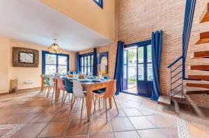 a dining room with a wooden table and chairs at Villa Lucentum in Alicante