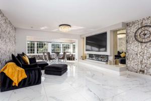 a living room with a fireplace and a tv at No22 Shalloch House - Donnini Apartments in Ayr