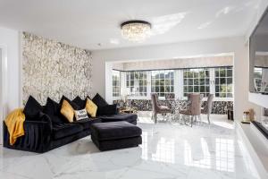 a living room with a couch and a table at No22 Shalloch House - Donnini Apartments in Ayr