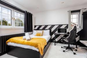 a bedroom with a bed and a desk and a computer at No22 Shalloch House - Donnini Apartments in Ayr +58 photos