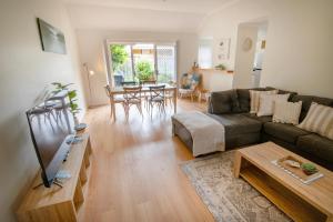 a living room with a couch and a table at Coastal Garden Villa in Albany