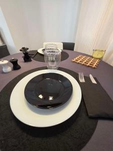 a table with a black and white plate on a table at Love room - L'escapade du désir in Trouillas