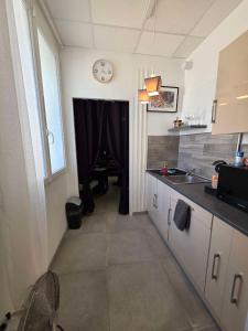 a kitchen with a sink and a window and a table at Love room - L'escapade du désir in Trouillas