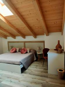 a bedroom with a bed and a wooden ceiling at Casa Cuor di Castagno in Roncegno