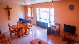 a living room with a dining room table and a television at Casa YilZil in Alpuyeca