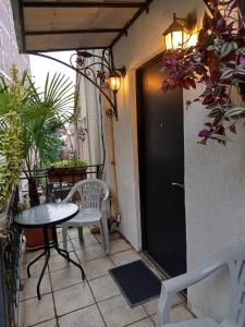 a small patio with a table and chairs on a balcony at Old Tbilisi Narikala Apartment in Tbilisi City