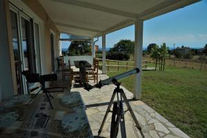 a telescope on the porch of a house at Sea Sight Greece in Angelochórion