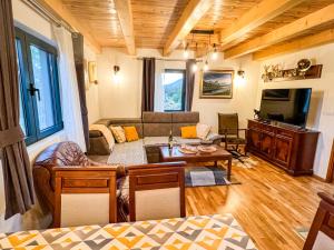 a living room with a couch and a table at Villas Hidden Paradise in Žabljak