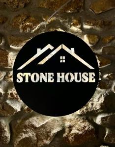 a stone house sign on a stone wall at Villa Stone House in Kutaisi Heliport +14 photos