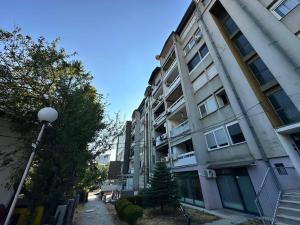an apartment building with a street light in front of it at Prishtina Center Apartment in Pristina