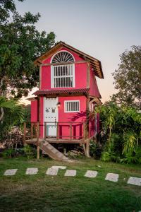 a red house on a wooden deck with a porch at Tiny Village Cartagena Boutique Resort in Tierra Bomba +66 photos