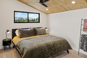 a bedroom with a bed and a window at OMI Combo in Creede, CO in Creede