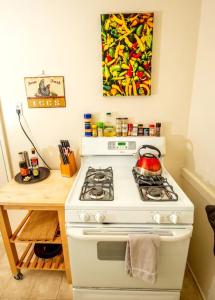 a kitchen with a stove with a tea kettle on it at The Marlowe Seaside Villa in Santa Barbara