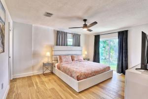 a bedroom with a bed and a ceiling fan at Parrots Cove in St Pete Beach +30 photos
