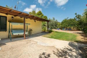 a porch with a bench and a gazebo at Chia Pool, 5 Rooms Per 12 People in Domus de Maria