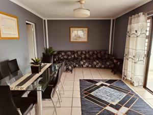 a living room with a couch and a table at Sir James Self Catering in Cape Town