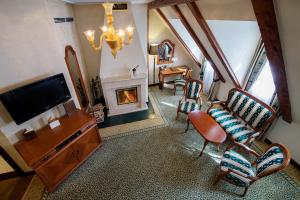 a living room with a tv and a fireplace at Arcadia Boutique Hotel in Bratislava