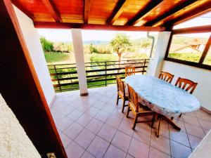 a porch with a table and chairs on a balcony at Apartment Tina in Karojba