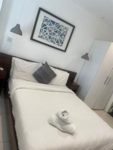 a bedroom with a bed with a towel on it at Afya's luxury Home Apt in Accra