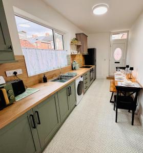 a kitchen with a counter and a sink and a table at Luxury flat next to Blyth Port in Blythe