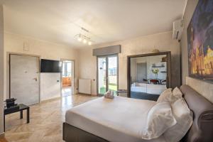 a large bedroom with a large white bed in a room at Penthouse Station luxury apts Le dimore in Brindisi