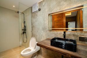a bathroom with a toilet and a sink and a shower at Anadolu Ubud in Ubud +28 photos