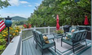 a deck with chairs and a table and umbrellas at The 19Th Hole - New Rental 2025 in Beaver Creek